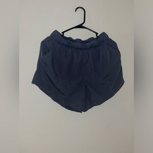 Dark blueish athletic shorts.